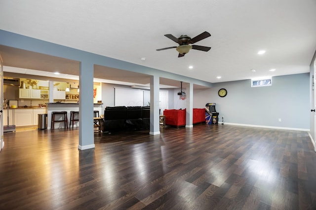 workout room with ceiling fan and dark hardwood / wood-style flooring