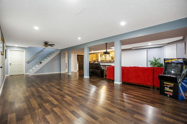 living room with dark hardwood / wood-style floors and ceiling fan