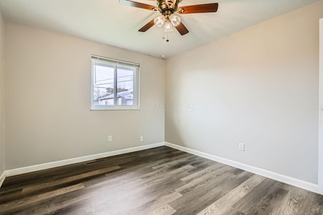 unfurnished room with dark hardwood / wood-style floors and ceiling fan