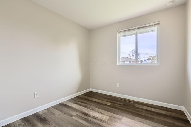 spare room with dark hardwood / wood-style floors