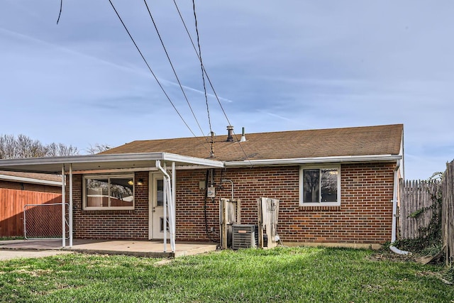 view of front of property with cooling unit, a patio area, and a front lawn