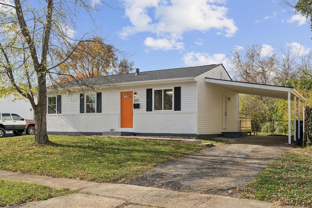 single story home with a front yard and a carport