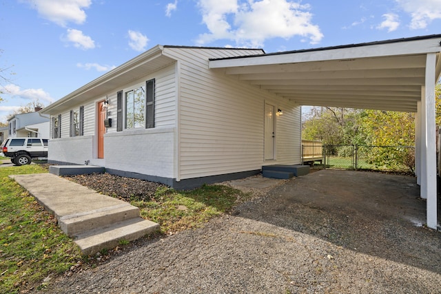 view of side of property featuring a carport