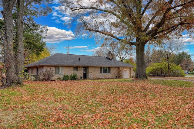 single story home featuring a garage and a front yard