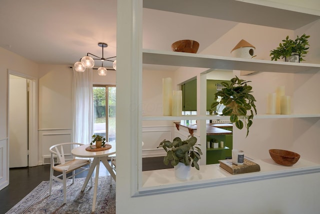 interior details featuring hardwood / wood-style floors and an inviting chandelier