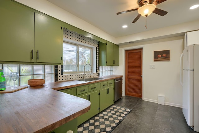 kitchen with stainless steel dishwasher, ceiling fan, sink, white fridge, and green cabinets