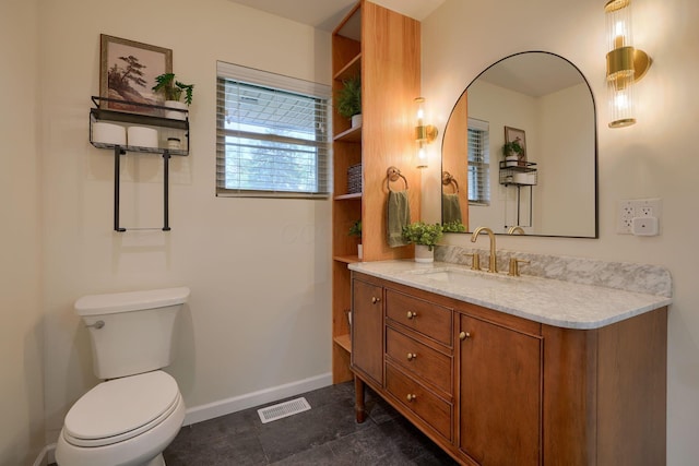 bathroom with tile patterned flooring, vanity, and toilet