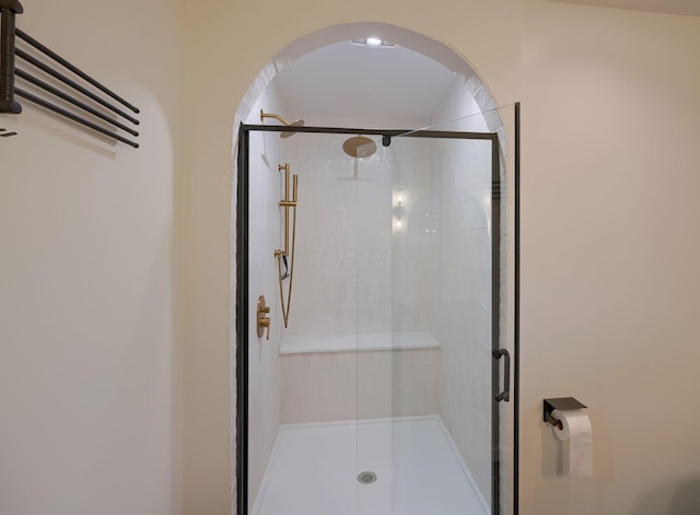 bathroom with a shower with door