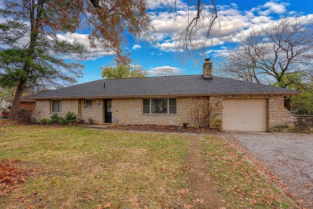 ranch-style home with a garage and a front lawn