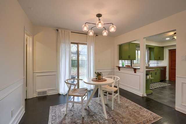 dining room with a notable chandelier and dark wood-type flooring