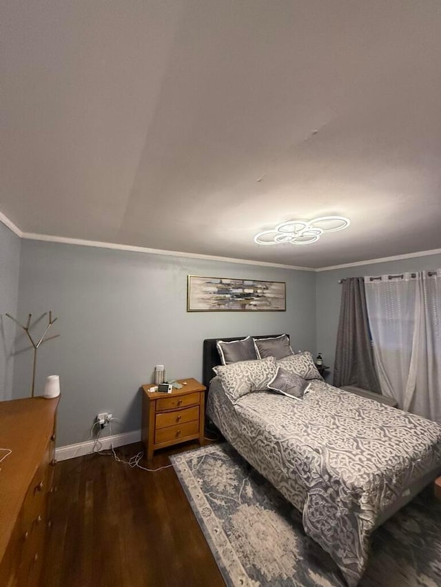 bedroom featuring dark hardwood / wood-style flooring and crown molding