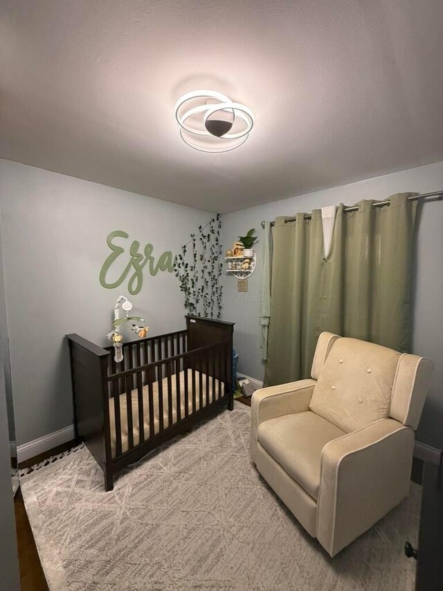 bedroom featuring a nursery area