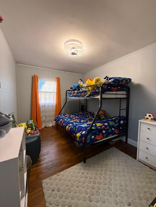 bedroom with dark hardwood / wood-style flooring