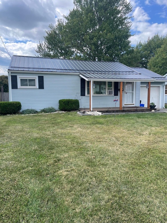 single story home with a garage and a front lawn