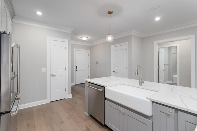 kitchen with decorative light fixtures, light stone counters, stainless steel appliances, and crown molding