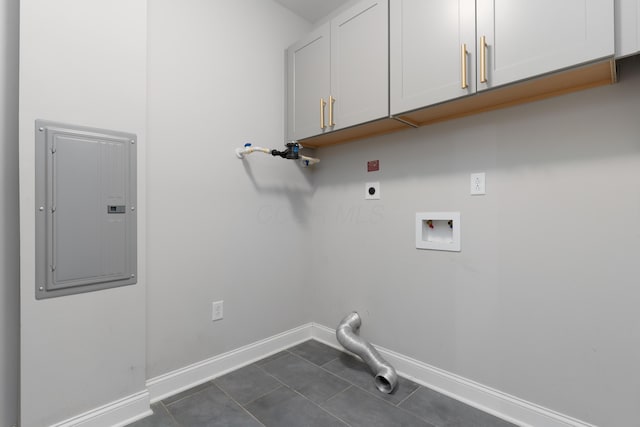 washroom featuring cabinets, hookup for an electric dryer, dark tile patterned floors, electric panel, and hookup for a washing machine