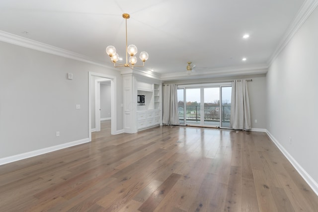 unfurnished living room featuring hardwood / wood-style flooring and crown molding