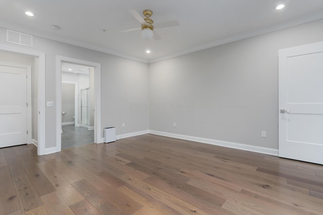 spare room featuring ceiling fan, wood-type flooring, and ornamental molding