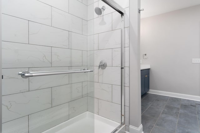 bathroom with tile patterned flooring, vanity, and a shower with door