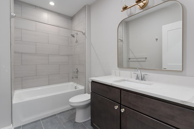 full bathroom featuring tile patterned floors, vanity, toilet, and tiled shower / bath