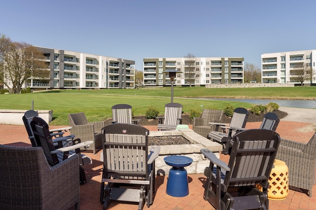 view of patio featuring a water view and a fire pit