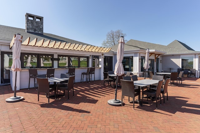 view of patio / terrace featuring an outdoor bar