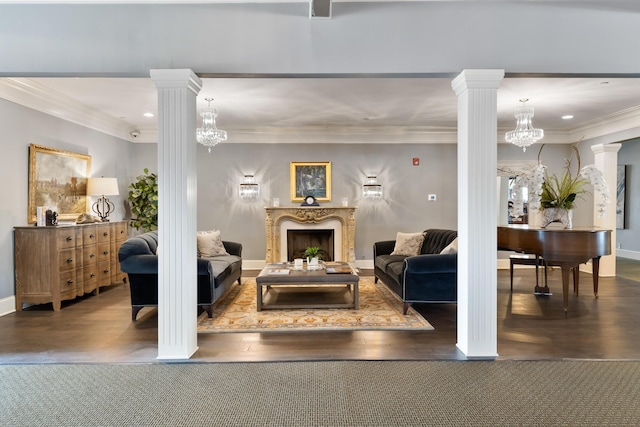 living room featuring dark hardwood / wood-style floors, an inviting chandelier, and ornamental molding