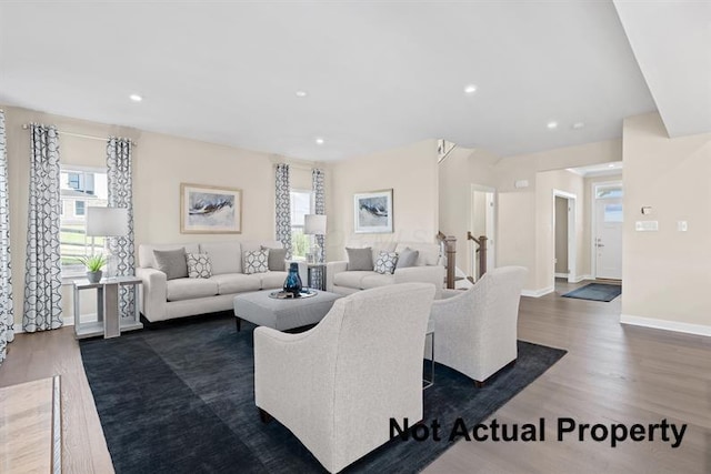 living room with dark hardwood / wood-style flooring and plenty of natural light