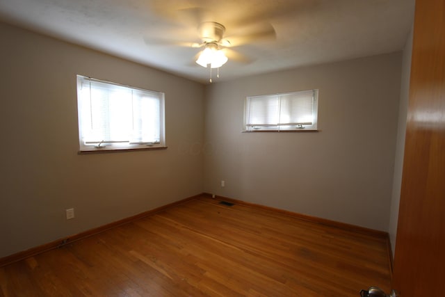 unfurnished room featuring hardwood / wood-style floors and ceiling fan