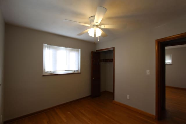 unfurnished bedroom featuring ceiling fan, a closet, and dark hardwood / wood-style floors