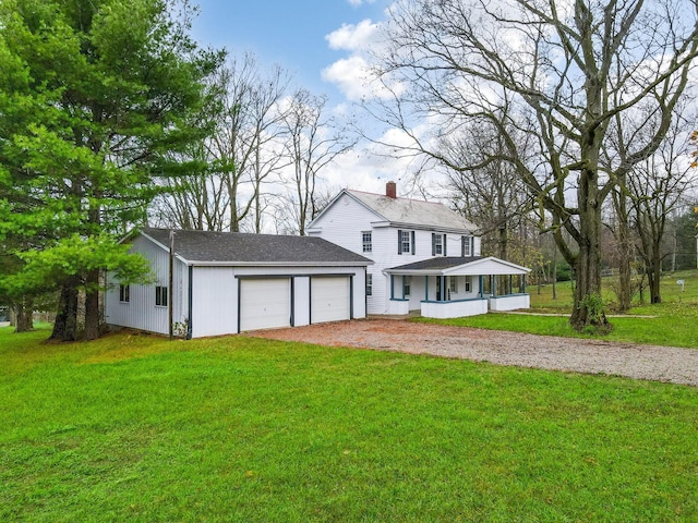 view of front facade with a front lawn, covered porch, and a garage