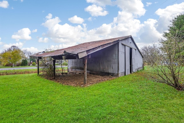 view of outbuilding featuring a lawn