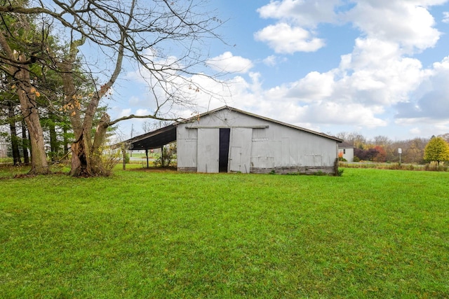 view of outbuilding featuring a lawn