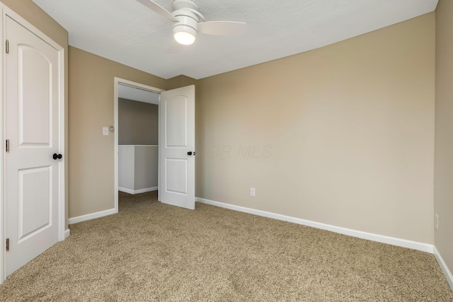 unfurnished bedroom with carpet floors and ceiling fan