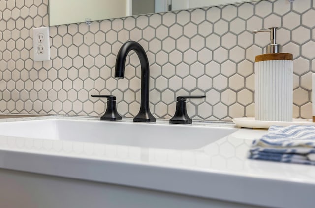 room details featuring decorative backsplash and sink