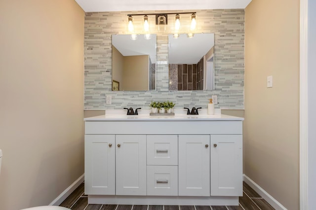 bathroom featuring vanity and backsplash