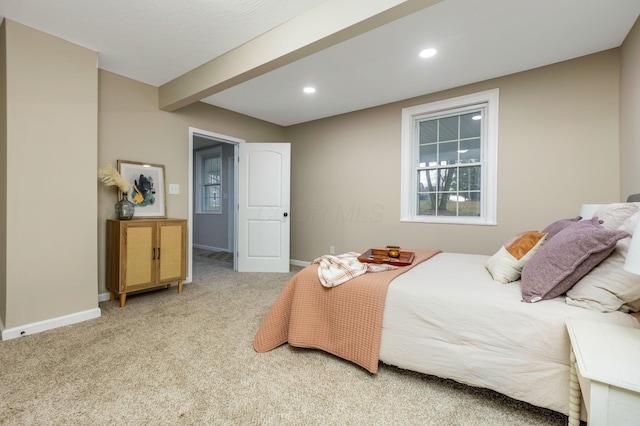 carpeted bedroom featuring beam ceiling