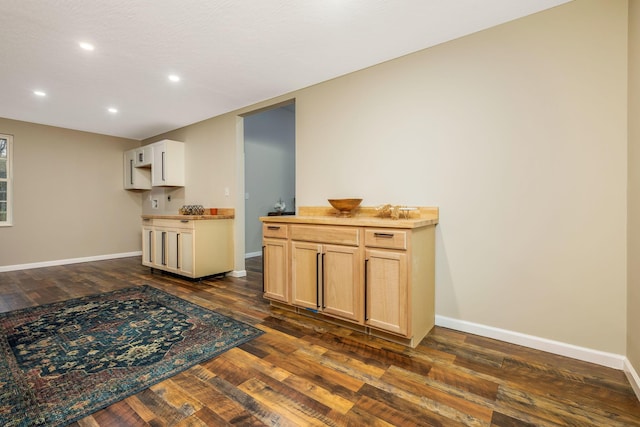 kitchen featuring wood counters, light brown cabinetry, and dark wood-type flooring