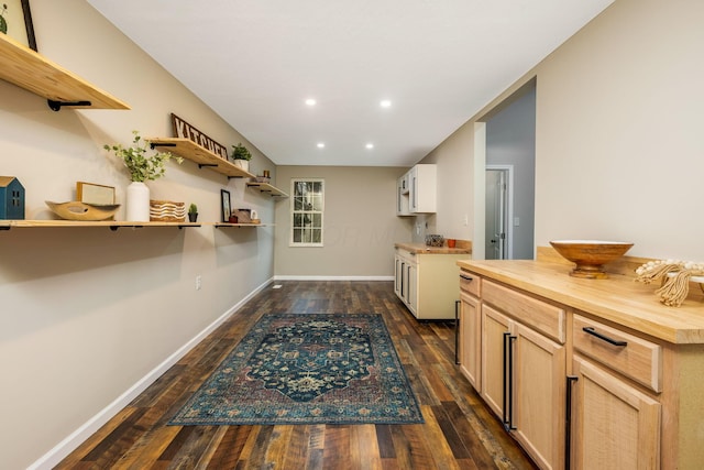 kitchen featuring light brown cabinets, wooden counters, and dark hardwood / wood-style floors