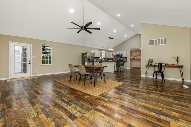 dining area featuring ceiling fan, dark hardwood / wood-style flooring, and high vaulted ceiling