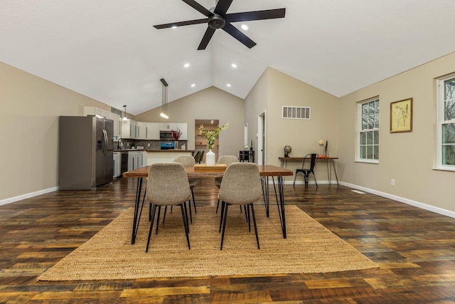 dining area featuring vaulted ceiling, ceiling fan, and dark hardwood / wood-style floors