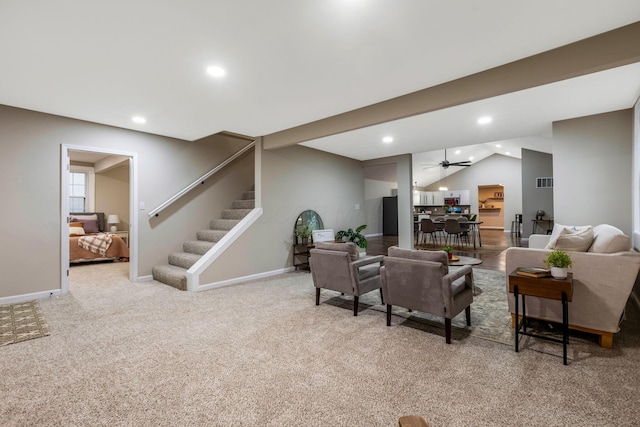 carpeted living room featuring ceiling fan and lofted ceiling