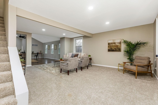 carpeted living room featuring ceiling fan and vaulted ceiling