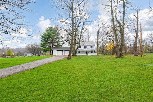 raised ranch with a front lawn and a garage