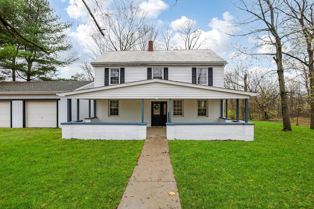 farmhouse featuring a garage, covered porch, an outbuilding, and a front lawn