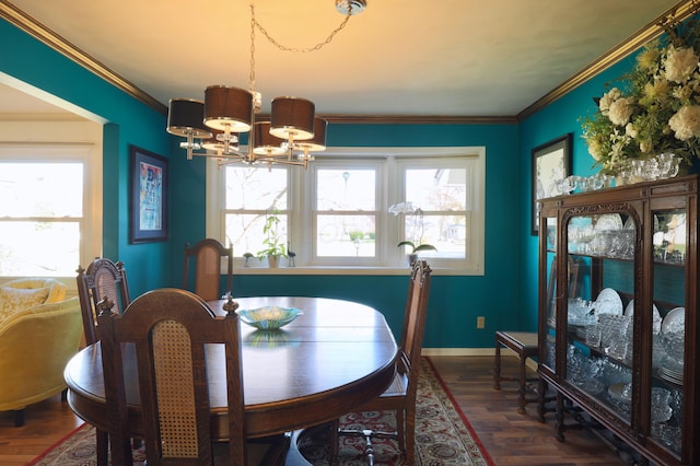 dining area featuring a chandelier, crown molding, and dark wood-type flooring