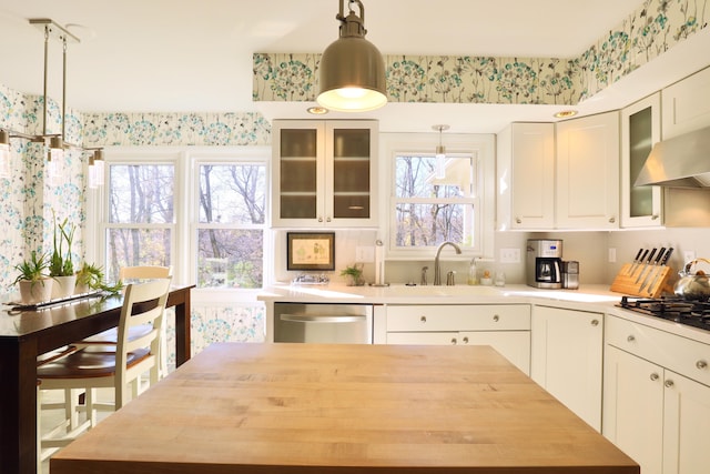 kitchen with gas cooktop, white cabinets, sink, decorative light fixtures, and dishwasher