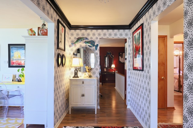 corridor featuring a notable chandelier, dark hardwood / wood-style floors, and ornamental molding