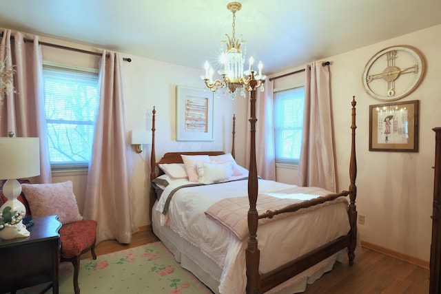 bedroom featuring light hardwood / wood-style floors and an inviting chandelier