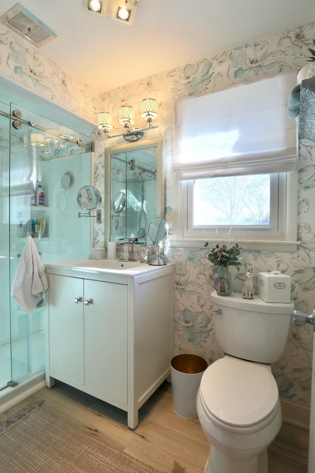 bathroom with hardwood / wood-style floors, vanity, and toilet